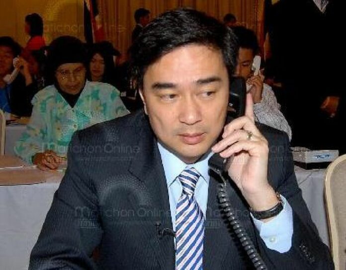 Former Prime Minister Abhisit Vejjajiva speaks on phone with members of the public, 2 July 2010.