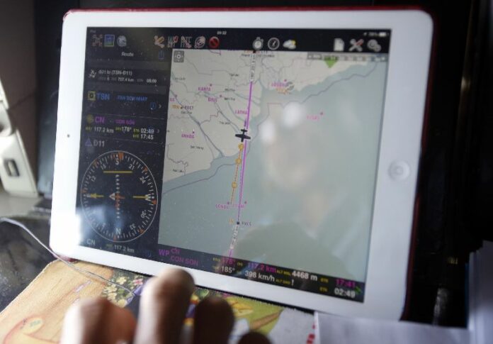 A Vietnamese military officer looks at the map of search operation for the missing Malaysian Airlines flight MH370, 12 March 2014 (Reuters)
