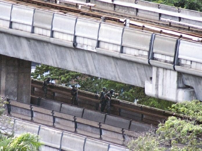 A still from a n amateur footage shows soldiers on BTS track in front of Wat Pathumwanararm Temple on 19 May 2010.