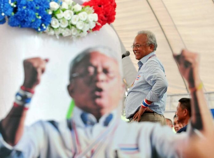 Anti-government protest leader Suthep Thaugsuban gives speech to demonstrators with a cardboard cutout of his likeness in the foreground, 5 April 2014
