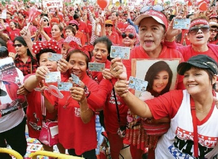 Redshirts protesters show their ID cards during a rally in Nakhon Pathom province, 5 April 2014