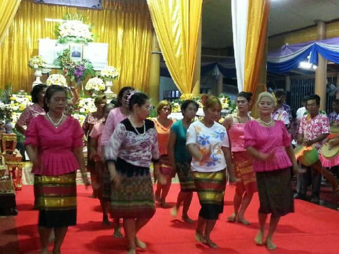 Musicians perform a festive traditional dance and music show at the funeral of their band founder in Ang Thong province, 18 April 2014.