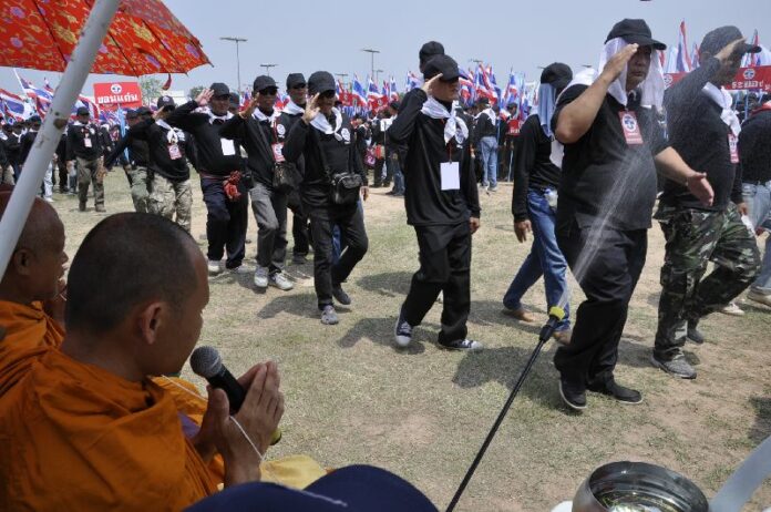 A monk blessing and spraying holy water on members of the National Volunteers for Defense of Democracy (NVDD) Nakhon Ratchasima, 21 April 2014.