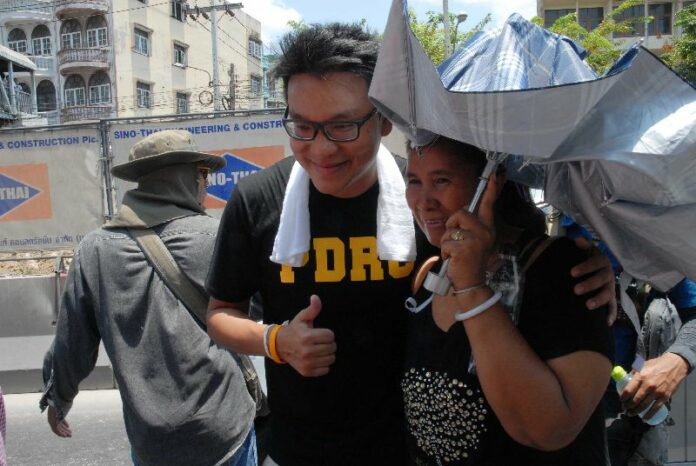 Sakoltee Phattiyakul, a prominent anti-government activist, poses for photo with a supporter on a march in Bang Khae district of Bangkok, 27 April 2014.