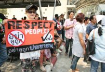 The Thai General Elections: A Catch 22 A pro-election demonstrator holds up a sign in 2014 at a polling station in Bangkok.