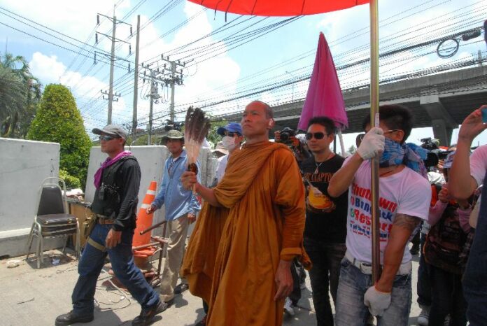 Buddhist monk and anti-government activist Buddha Issara leads protesters to the CAPO headquarters, May 2014.