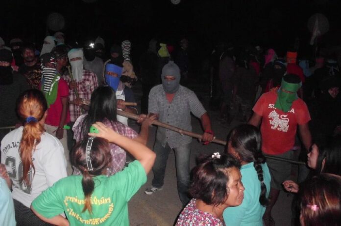 Hundreds of masked men attack villagers protesting the chemical contamination from a local gold mine in 2014