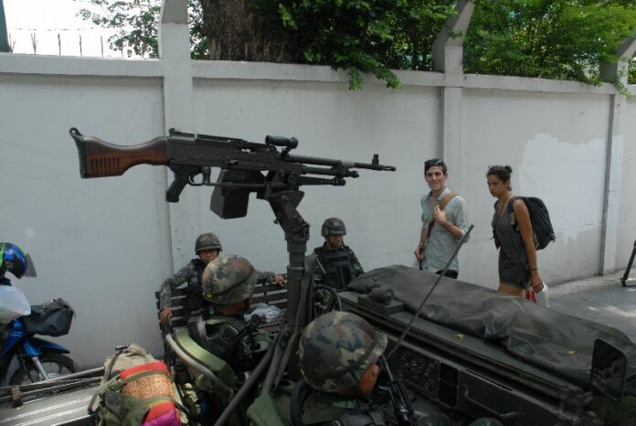 Military jeep mounted with a machine gun stands guard on Ratchadamri Road in Bangkok, 20 May 2014