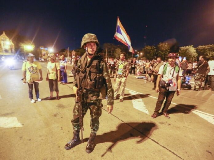 A Thai soldier stands guard outside the Government House in Bangkok after the army declared a coup (DPA).