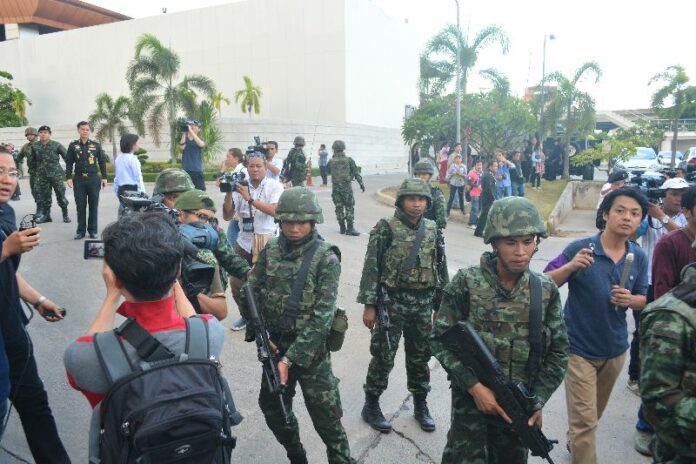 Soldiers disperse reporters outside the army club following the 22 May coup d'etat.