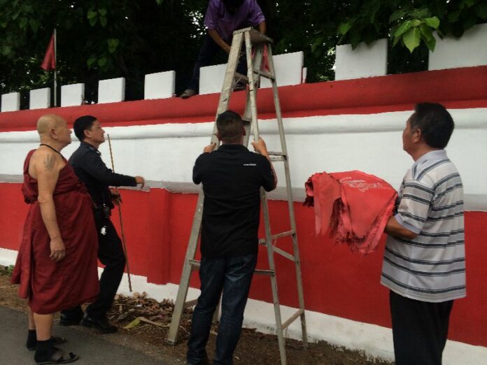 Police take down Redshirt flags from Wat Sri Boon Reung Temple, Mueang district, Chiang Mai, 29 May 2014.