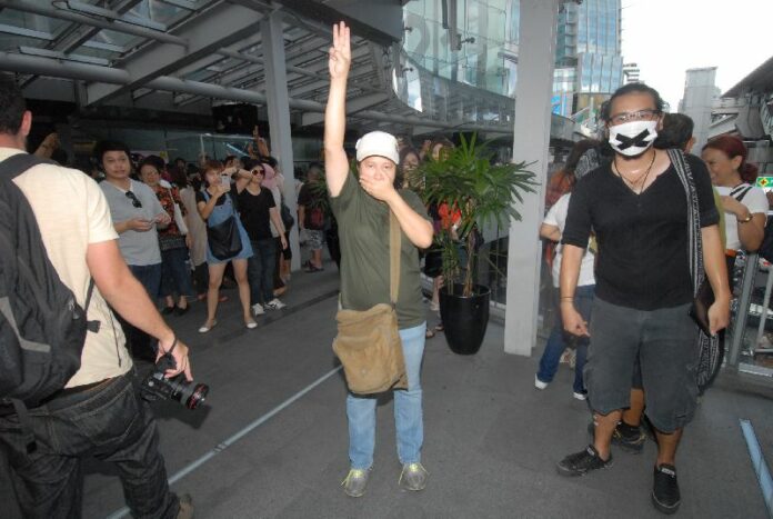 A protester flashes the three-finger salute at an anti-coup demonstration at Terminal 21 Mall in Bangkok on 1 June 2014.
