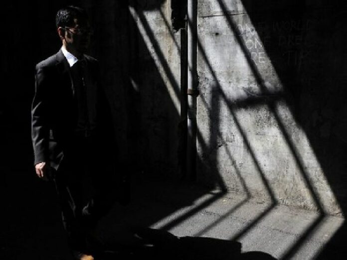 A man walks through a beam of sun light under a bridge in Tokyo, Japan, 13 May 2010. The high suicide rate among young Japanese has made it the leading cause of death for the age group for the seventh straight year. EPA/FRANCK ROBICHON