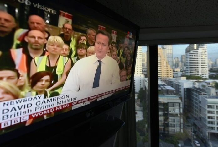 British prime minister David Cameron and the logo of the BBC World News is seen on a TV screen in Bangkok, Thailand, 03 June 2014. The Thai military has unblocked international TV news channels like BBC and CNN after they were taken off the air when the military took over power on 22 May. EPA/UDO WEITZ