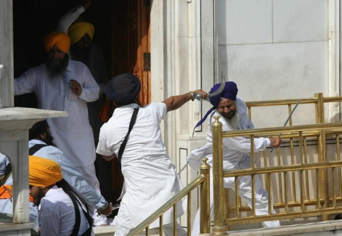 Members of Sikh radical groups clash with Shiromani Gurudwara Prabhandak Committee (SGPC) supporters, after a prayer and remembrance meeting for the Sikh separatists who lost their lives during Operation Blue Star in 1984 at the Golden Temple EPA/RAMINDER PAL SINGH
