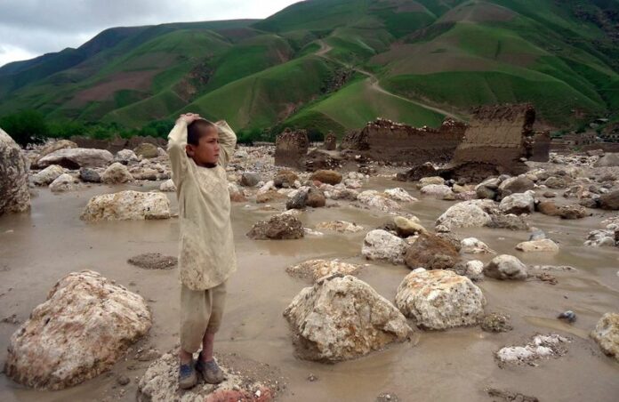 An Afghan child displaced by floods waits for help near his house in Baghlan, Afghanistan, 23 April 2012. EPA/NAQEEB AHMED/ARCHIVE<br />