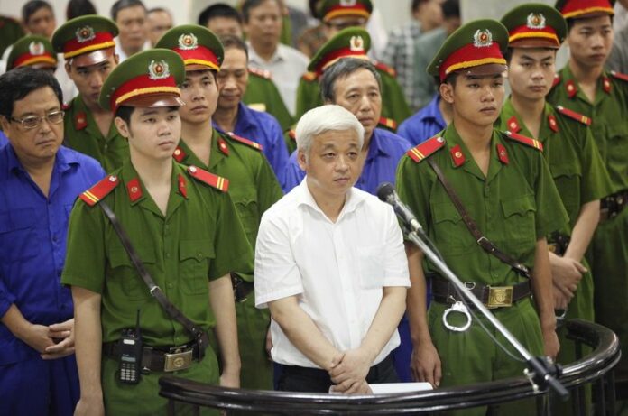 Asia Commercial Bank founder Nguyen Duc Kien stands during his trial in Hanoi. Kien, a tycoon who started one of Vietnam's largest private banks was sentenced to 30 years in prison for fraud, tax evasion and conducting illegal business activities. EPA/STR
