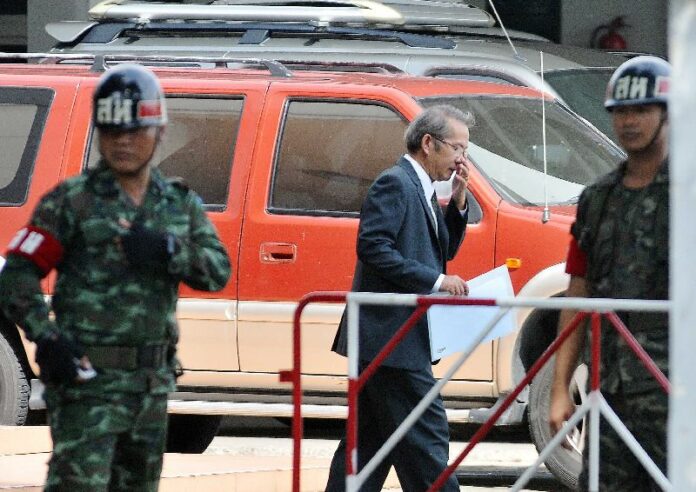 One of the 33 individuals summoned last night reports to the military junta at the Army Club in Bangkok on 18 June 2014.
