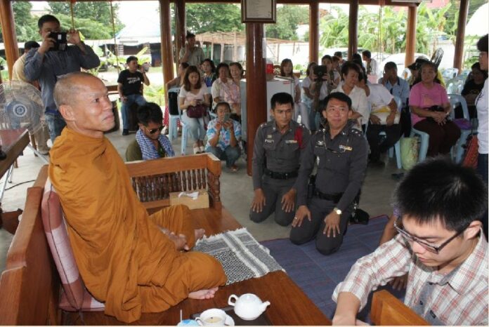 Activist monk Buddha Issara blesses supporters who visited his home in Bangkok on 26 June, 2014.