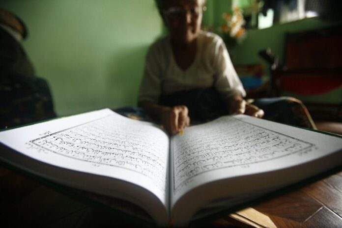 The Muslim mother-in-law of a converted Buddhist reads the Quran at her house in Yangon, Myanmar, 28 June 2014. Religious tolerance and diversity in Myanmar is being threatened by an anti-Muslim backlash among radical Buddhists. EPA/LYNN BO BO