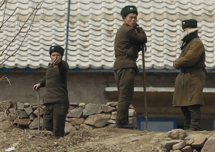 A North Korean soldier photographed along the North Korean bank of the Yalu River, 06 April 2013. Two US citizens have been charged with "perpetrating hostile acts after entering the territory," Pyongyang's state-run news agency said Monday. EPA/HOW HWEE YOUNG