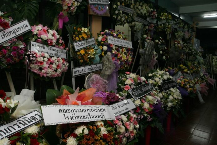 Wreaths placed during the funeral of a 13-year-old girl who was raped and murdered on a night train over the weekend.