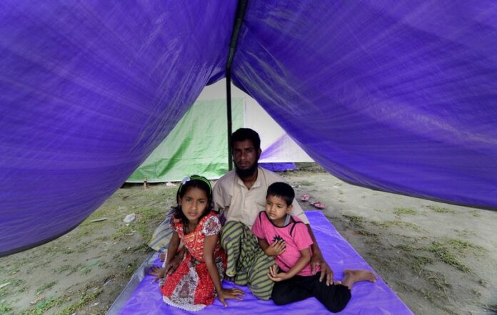 Saidul Islam in a file photo along with his two daughters Sazda Khatu and Mazda Khatut take shelter in relief camp after their mother was killed by militants in Narayanguri village in Assam, India, in May. A militant group called National Democratic Front of Bodoland (IK Songbijit faction) was suspected to be behind the killings. EPA/STR/ARCHIVE