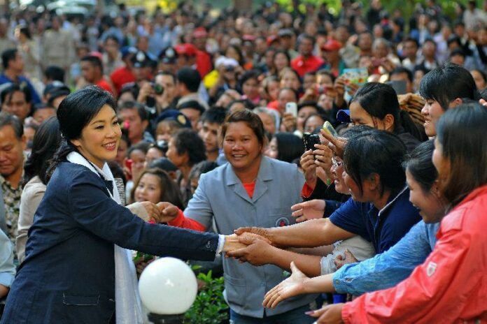 Former Thai Prime Minister Yingluck Shinawatra greets supporters on 24 December 2014.<br />
