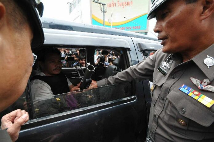 A suspect shows police how he allegedly fired a grenade at anti-government protesters, 15 July 2014.<br />