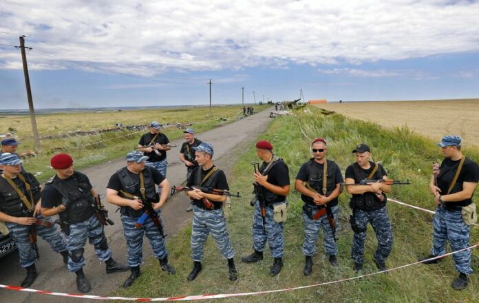 Armed rebel soldiers block access to the main crash site of the Boeing 777 Malaysia Airlines flight MH17, on Sunday. The plane went down on Thursday between the city of Donetsk and the Russian border, an area that has seen heavy fighting between separatists and Ukrainian government forces. EPA/ROBERT GHEMENT
