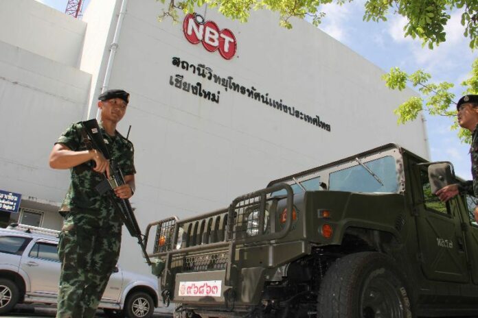 Soldiers in front of the regional office of National Broadcasting Service of Thailand (NBT) in Chiang Mai province, 20 May 2014