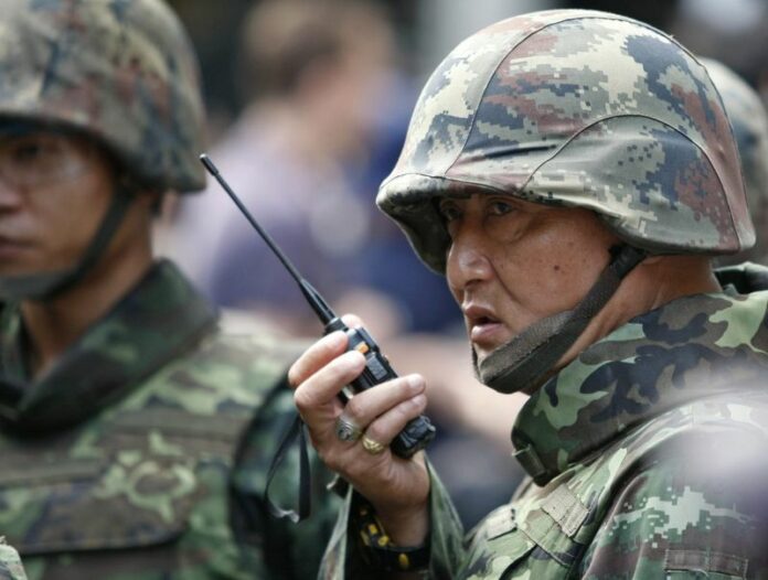 A Thai soldier uses a radio as security forces work to prevent an anti-coup demonstration at Ratchaprasong shopping district in Bangkok, Thailand, 01 June 2014. Recent polls in Thailand suggest that a majority of the population supports the military rule which followed the country's May coup. EPA/PONGMANAT TASIRI