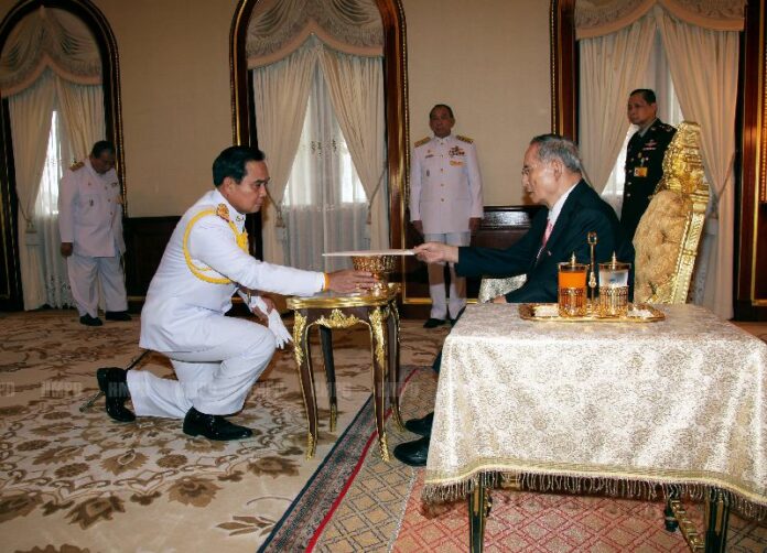 NCPO chairman Gen. Prayuth Chan-ocha receiving the 2014 Interim Constitution from His Majesty the King, 22 July 2014.