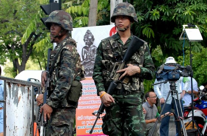 Soldiers stand guard outside Army Club in Bangkok on 23 May 2014.