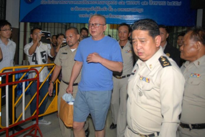 The founder of Yellowshirt movement, Sondhi Limthingkul, escorted to a prison van from the Court of Appeals in Bangkok, 7 August 2014.