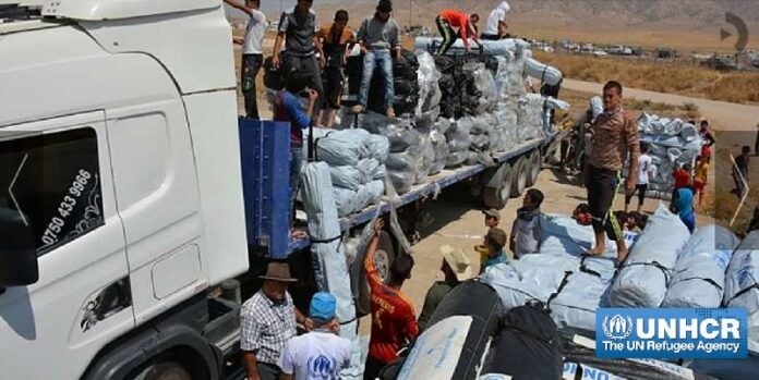 Workers unload trucks laden with hundreds of tents for families displaced by the recent fighting in Iraq. Shelter is a priority for the displaced, many of who are living rough in unfinished buildings, schools, mosques, churches and parks.