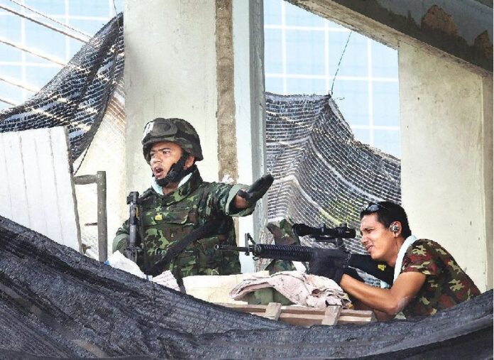 A military sniper shoots at Redshirt protesters near Lumpini Park on 15 May, 2014.