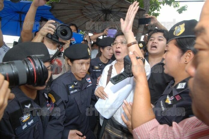 Police officers arrested Payao Akhart and her son Nattapat Akhart while they were waiting to stage a protest near the BTS Station, 31 August 2014.