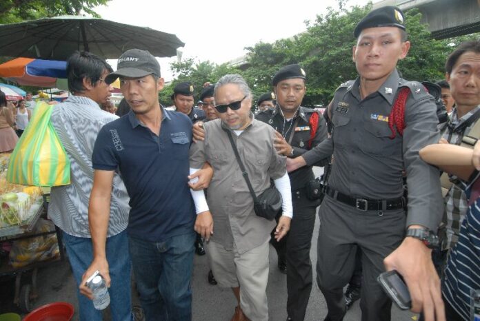 Police detained Mr. Pansak soon after he began casting bundles of flyers around the station.