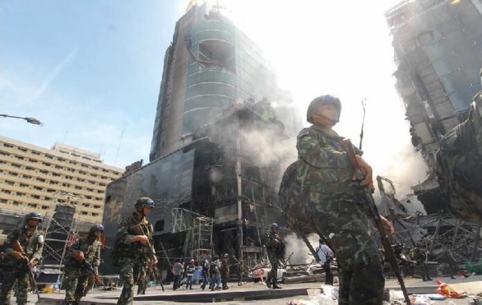 Soldiers stand by the charred Central World shopping mall on 20 May, 2014.