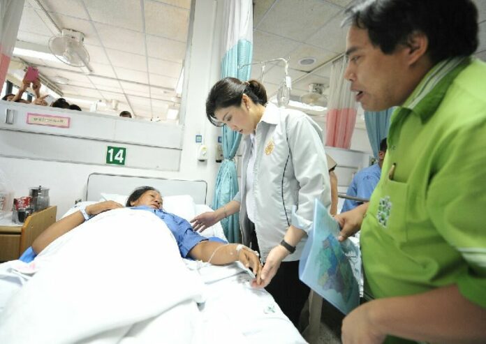 Then-Prime Minister Yingluck Shinawatra visiting a victim of the explosion in Map Ta Phut Industrial Estate in Rayong province on 5 May 2012.