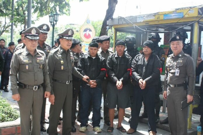 The suspects reenacted their alleged crimes for police in downtown Bangkok, 12 Sept 2014.