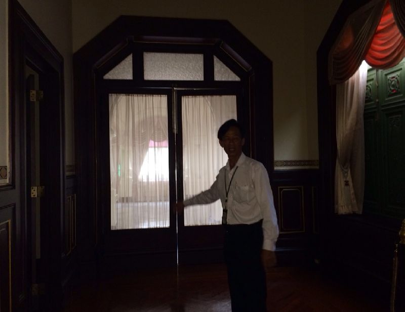 Sinsakorn Aroon, a 60-year-old official, pointing to where he saw a ghostly phenomenon inside the Government House, 11 Sept 2014.
