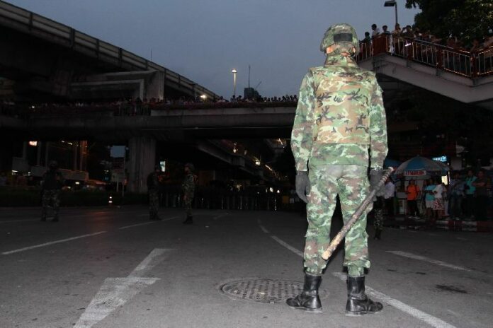 Soldiers stand guard at an anti-coup protest near Victory Monument in Bangkok, 26 May 2014.