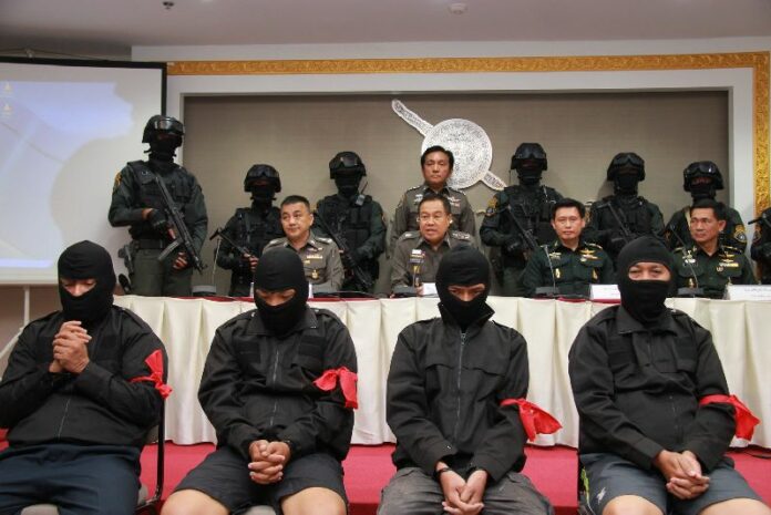 The five suspected Blackshirts were dressed in black clothing with red arm bands for the police press conference announcing their arrests on 11 Sept 2014.