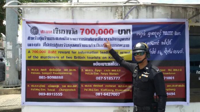 A banner hung on Koh Tao promising 700,000 baht reward for providing information that leads to the arrest of a culprit behind the Koh Tao muders. 24 Sep 2014.<br />