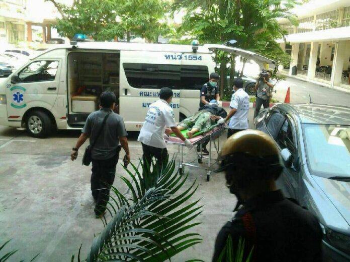 Rescue workers bring Sangwian Raksapetch, 52, to the hospital after she set herself on fire in side the government complaint centre in Bangkok, 15 Oct 2014. <br />