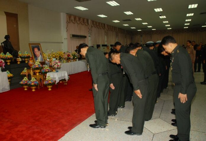 Military officers bow before a portray of His Majesty the King, who is currently recovering from a gallbladder operation in the hospital.