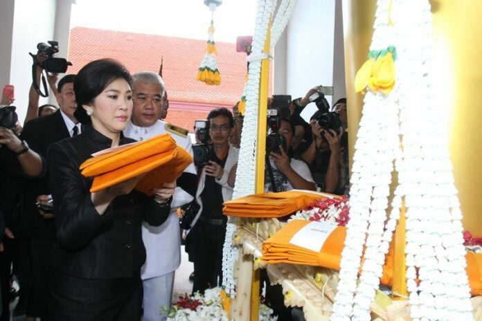 Yingluck Shinawatra at the funeral of a former Pheu Thai MP on 19 Oct 2014. She left for Japan later that night.<br />