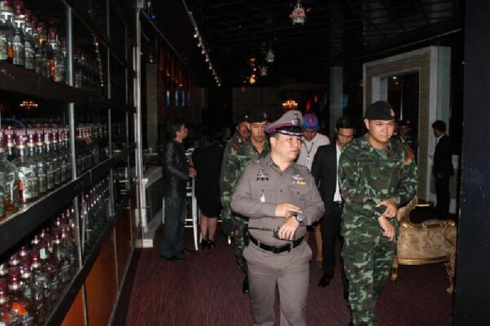 Soldiers and police raid a nightclub in Bangkok's Thong Lor district to enforce the post-coup midnight - 4 am curfew on 10 June 2014. The curfew was later lifted, but martial law has been retained by the junta. <br />